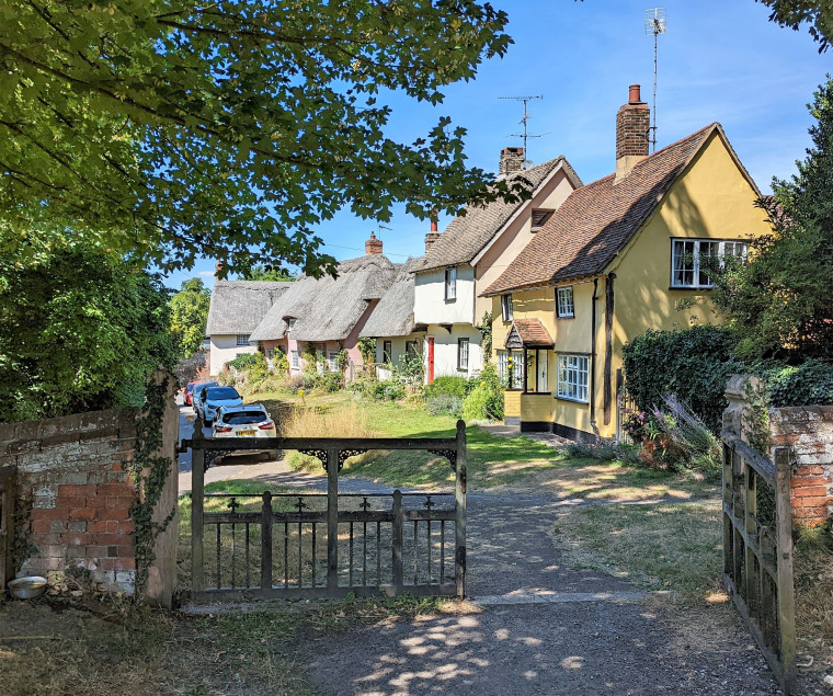 Wendens Ambo Cottages and Cars from Church 7 August 2022 Copyright: William George