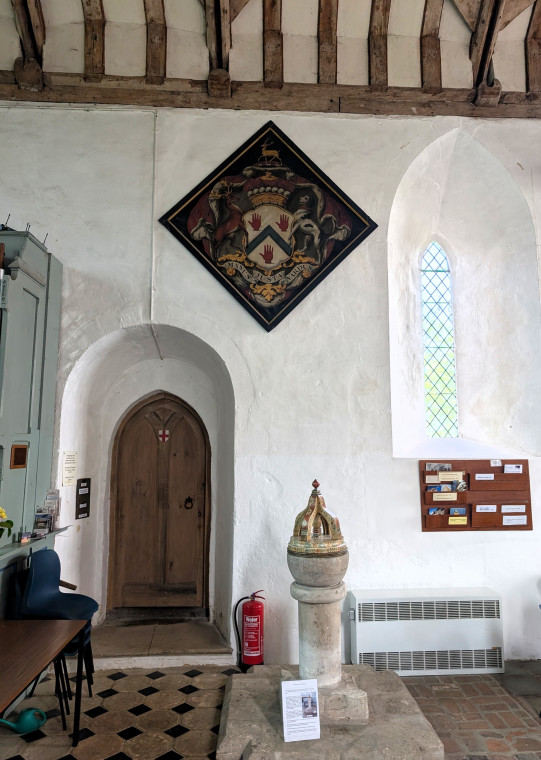 Tilty Church North Wall with font and hatchment 17 June 2025 Copyright: William George